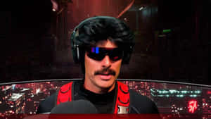 A Man With A Mustache And Headphones Is Sitting In Front Of A Computer Wallpaper