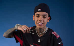 A Man With Tattoos And A Football Jersey Wallpaper