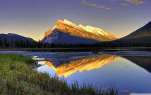 A Mountain Is Reflected In A Lake Wallpaper