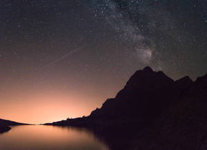 A Mountain Range With A Lake Wallpaper