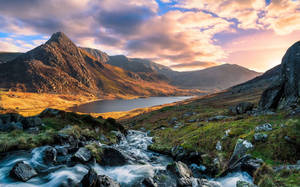 A Mountain Stream Runs Through The Mountains Wallpaper