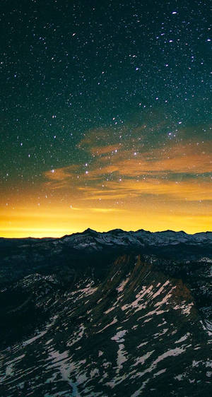 A Mountain With Snow And Stars In The Sky Wallpaper