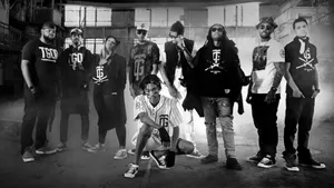A Mysterious Gang Standing In The Shadows Wallpaper