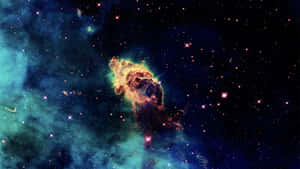 A Mysterious Nebula Illuminated By The Light Of Brilliant Stars Wallpaper