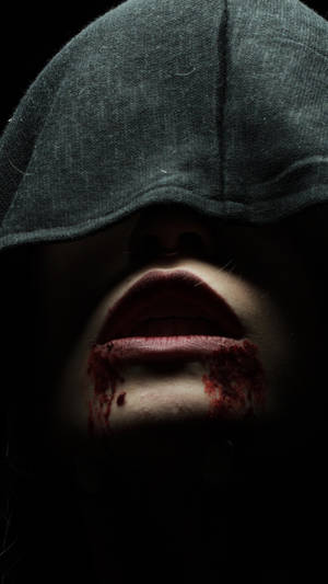 A Mysterious Vampire Covered In A Dark Hood And Drenched With Blood Wallpaper