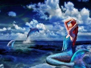 A Mystical Mermaid Rises From The Ocean Depths Wallpaper