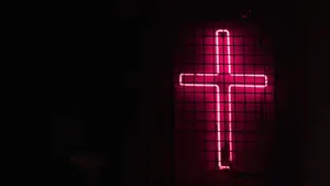 A Neon Cross Creates A Mystical Scene Of Faith Wallpaper