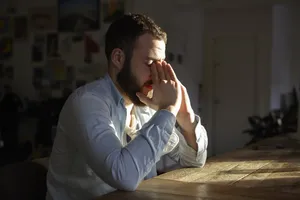 A Overwhelmed Man Crumbling Under Stress Wallpaper