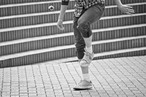 A Passionate Player Kicking Hacky Sack In Action Wallpaper