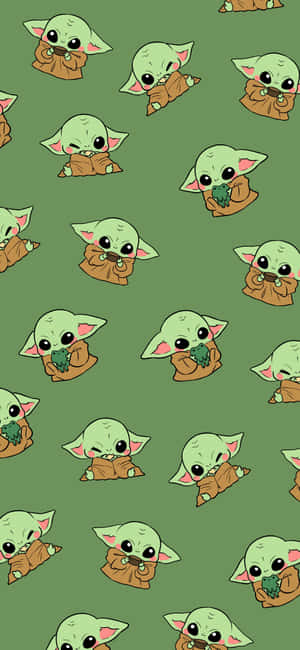 A Pattern Of Baby Yoda On A Green Background Wallpaper