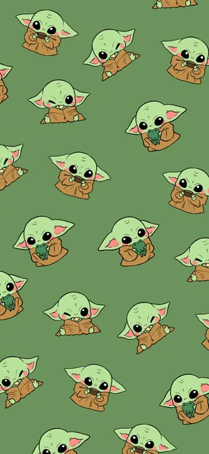 A Pattern Of Baby Yoda On A Green Background Wallpaper