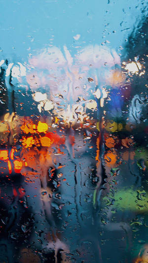 A Peaceful View - Rain Falling Softly Outside A Window Wallpaper