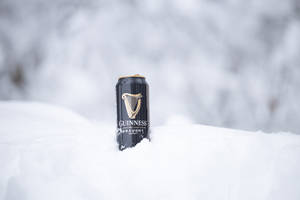 A Perfect Guinness Moment: Chilled Irish Stout In Snow Wallpaper