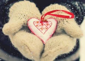 A Person Holding A Heart Ornament Wallpaper