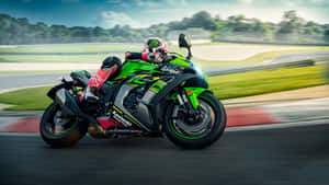 A Person Riding A Green Motorcycle On A Track Wallpaper