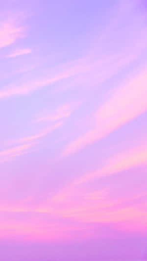 A Pink And Purple Sky With Clouds Wallpaper