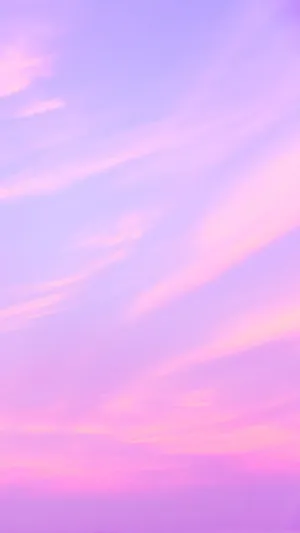 A Pink And Purple Sky With Clouds Wallpaper