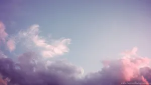 A Pink And Purple Sky With Clouds Wallpaper