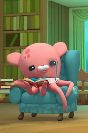 A Pink Octopus Sitting In A Chair Reading A Book Wallpaper