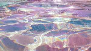 A Pool With A Rainbow Colored Water Wallpaper