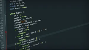 A Programmer Coding On A Computer Desktop. Wallpaper