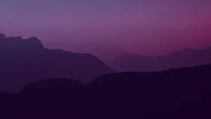 A Purple Sky With Mountains Wallpaper