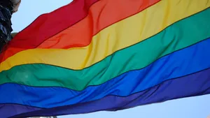 A Rainbow Flag Is Flying In The Wind Wallpaper