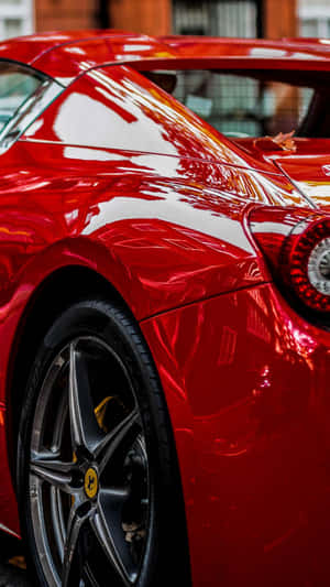 A Red Car Against The Backdrop Of A Stunning Sunset Wallpaper