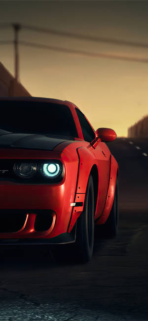 A Red Car Driving Down The Road Wallpaper