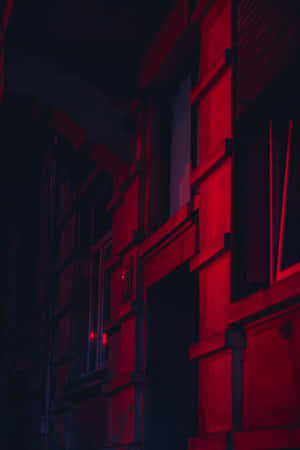 A Red Light Is Shining On A Building Wallpaper
