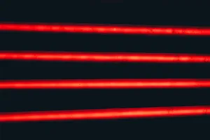 A Red Line Cascades Through The Night Sky Wallpaper