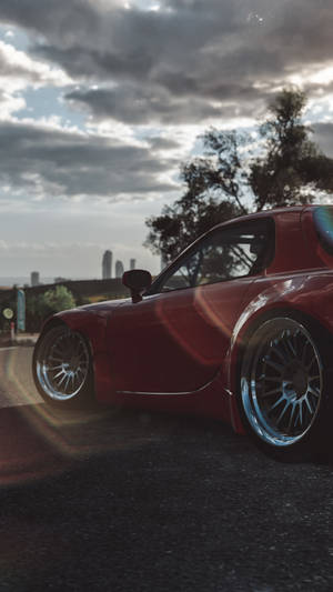 A Red Sports Car Is Parked In The Street Wallpaper