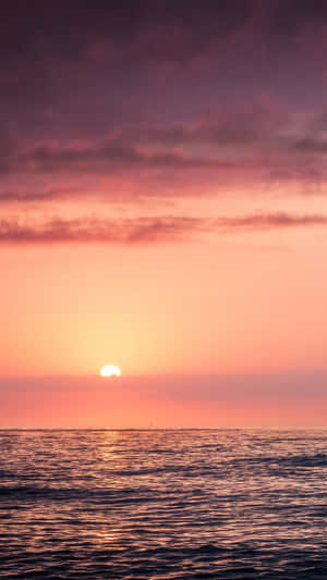 A Romantic Orange Sunset Over The Beach Wallpaper