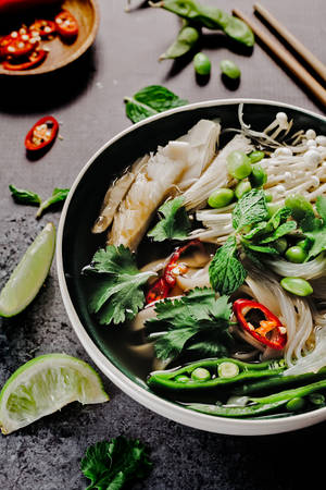 A Satisfying Bowl Of Pho: Traditional Vietnamese Noodle Soup With Fresh Vegetables. Wallpaper