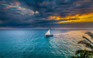 A Secluded Voyage - Serene Sailboat At Sunset Wallpaper