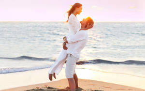 A Serene Moment Of Love At The Beach Wallpaper