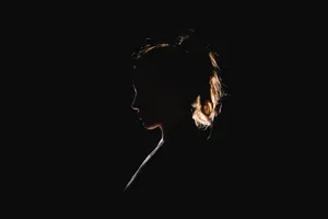 A Silhouette Of A Beautiful Black Girl Embracing The Sunset Wallpaper