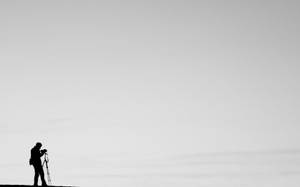 A Silhouette Of A Minimal Photographer Wallpaper