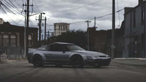 A Silver Sports Car Parked On A Street Wallpaper