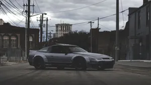 A Silver Sports Car Parked On A Street Wallpaper