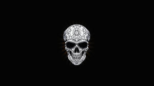 A Sinister Black Skull Looking Out From Its Ominous Dark Background. Wallpaper