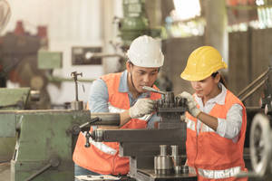 A Skilled Heavy Equipment Operator Hard At Work Against The Industrial Backdrop. Wallpaper