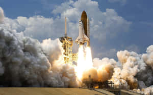 A Space Shuttle Is Taking Off With Smoke Coming Out Of It Wallpaper