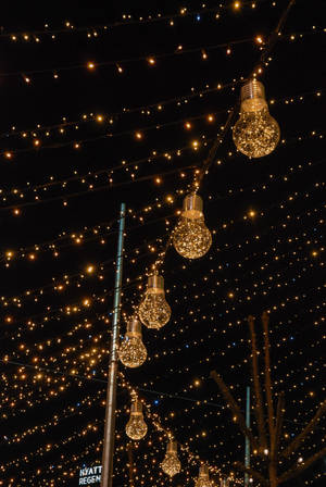 A Street With Lights And A Christmas Tree Wallpaper