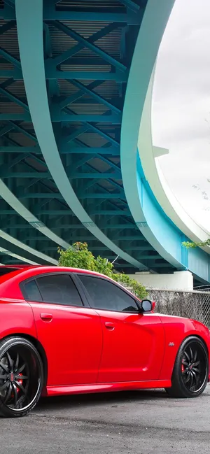 A Stunning, Bright Red Car Illuminated By The Early Morning Sun. Wallpaper