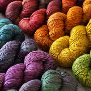 A Stunning Display Of Multicolor Knitting Yarns Wallpaper