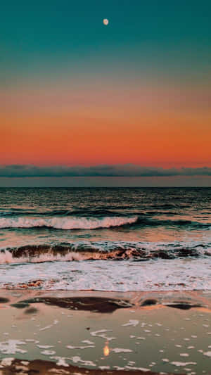 A Sunset On The Beach With The Moon Reflecting In The Water Wallpaper