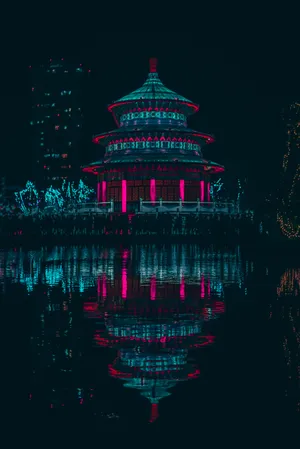 A Tranquil Pagoda Illuminated By The Stars. Wallpaper