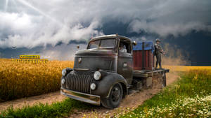 A Truck Driving Down A Road Wallpaper