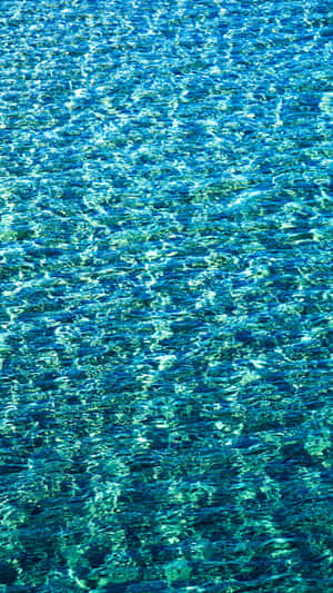 A Turquoise Iphone, With A Sleek Finish And Vibrant Color. Wallpaper